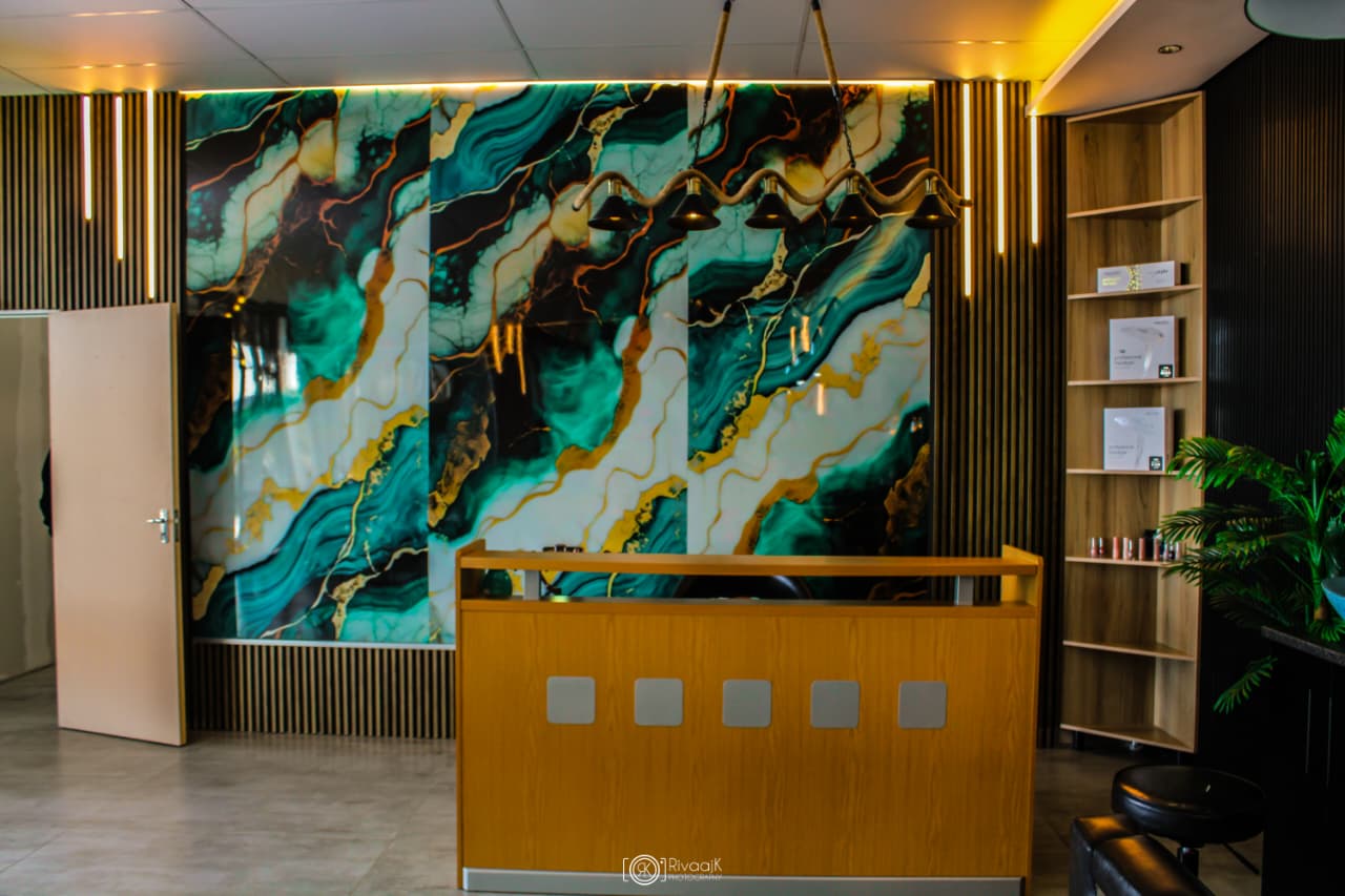Changing Faces reception area with teal marble wall